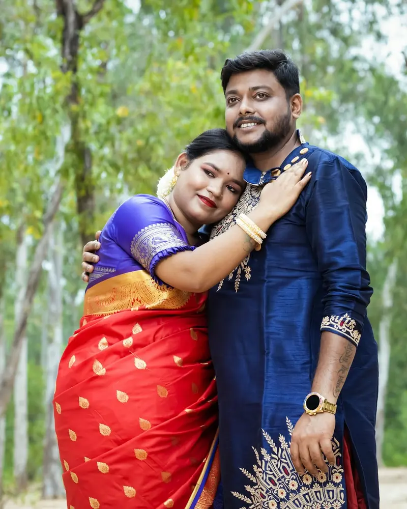 An Indian couple embracing in a eucalyptus grove